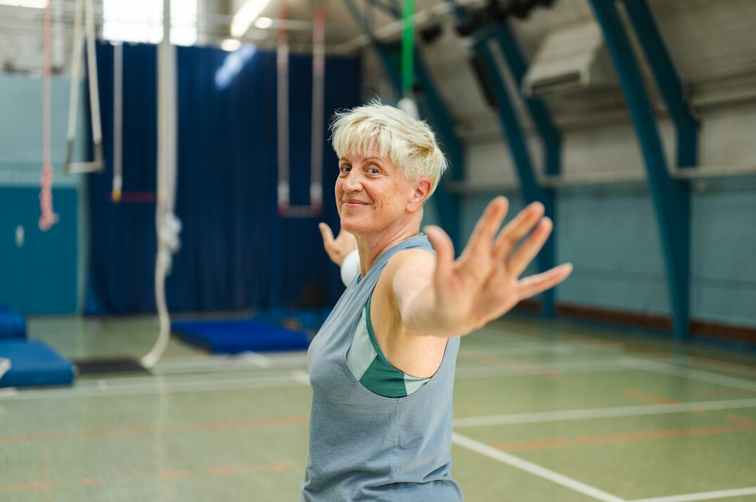 smiling elderly woman in gym